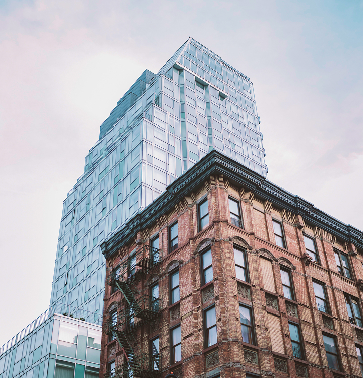 Glass building behind brick building